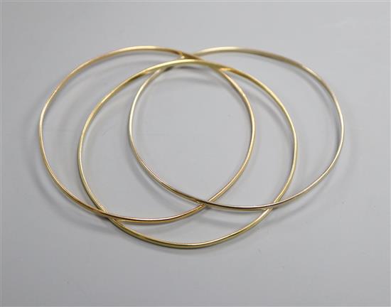 An Italian three colour 750 yellow metal triple bangle.